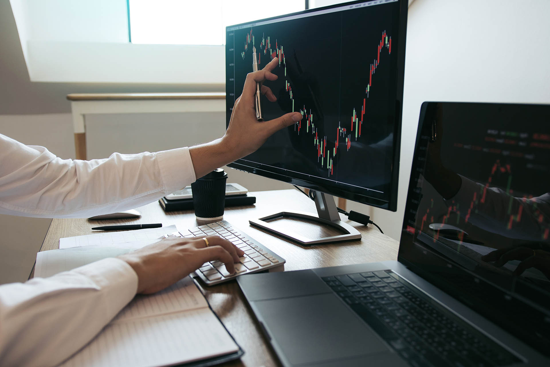 Close up of hand investors are pointing to laptop computer that
